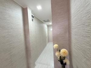 a hallway with two vases with flowers in it at Grand hotel dmanisi in Dmanisi