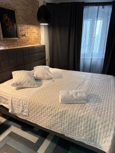 a bed with two pillows on it in a bedroom at Apartments Kremenic in Cres