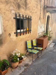 a couple of chairs sitting next to a building at Bella Vista Cabris in Cabris
