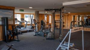 a gym with several tread machines in a room at Apartments Klövsjöfjäll in Klövsjö