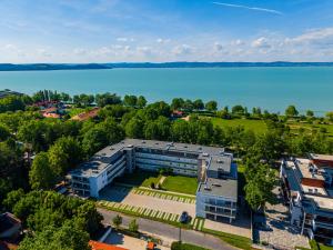 an aerial view of a building next to a lake at Sunshine Homes Zamárdi in Zamárdi
