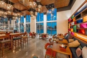 a restaurant with tables and chairs and large windows at Wink Tuy Hoa Beach, Unscripted by Hyatt - 24 Hours stay in Tuy Hoa +54 photos