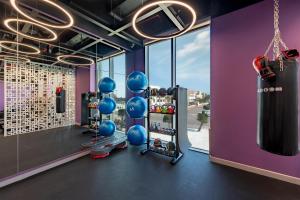 a gym with a punching bag and blue balls at Wink Tuy Hoa Beach, Unscripted by Hyatt - 24 Hours stay in Tuy Hoa
