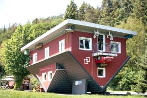 a red house with a staircase leading up to it at Ferienhaus Leni in Edertal