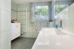 a bathroom with a large white sink and a window at Ferienhaus Leni in Edertal +31 photos