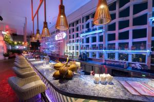 a bar in a hotel with chairs and lights at Wink Hai Phong Centre, Unscripted by Hyatt - 24 Hours stay in Hai Phong