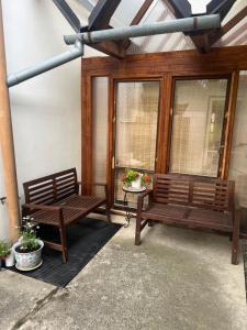 two benches sitting on a patio with windows at U babičky in Suchov