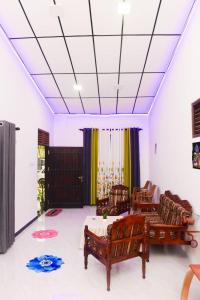a room with two chairs and a bed in it at Bule Bells Villa in Matara +3 photos