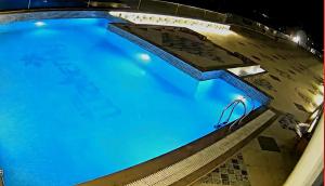an overhead view of a swimming pool at night at Hotel Waterlily in Indore +12 photos
