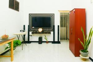 a living room with a tv on a wall at Bule Bells Villa in Matara