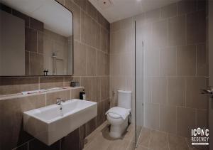 a bathroom with a sink and a toilet and a mirror at Iconic Regency Service Residences, managed by Iconic Hotel in Bayan Lepas +22 photos