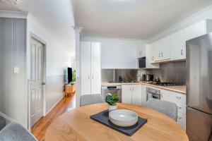a kitchen with a wooden table with a bowl on it at 5-41 Park Street in Evans Head