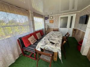 a dining room with a table and a couch in a trailer at Rapan Guesthouse in Bŭlgarevo
