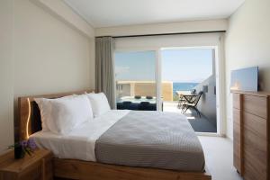 a bedroom with a bed and a view of the ocean at Virea VA Complex in Vaia