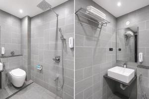 a bathroom with a shower and a toilet and a sink at FabHotel JM Residency in Mandrem +37 photos