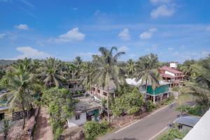 an aerial view of a village with palm trees at FabHotel JM Residency in Mandrem