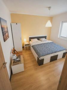 a bedroom with a large bed in a room at 3 Stars Apartments in Prilep