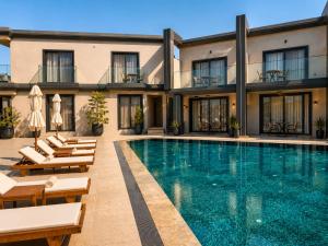 a swimming pool in front of a building at The Sign Highlight Hotel in Bodrum City