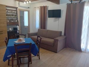 a living room with a table and a couch at Casa Dora in Porto Pino