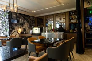 a restaurant with tables and chairs and a counter at Meritin Hotel in Kuching