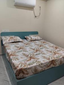 a bed in a room with a bedskirtspectspectspects at Venya Vihar Vizag MVP AC Deluxe 1 BHK Studio Apartment in Visakhapatnam
