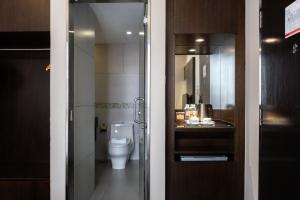 a bathroom with a toilet and a sink at Meritin Hotel in Kuching +63 photos