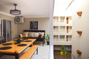 a living room with a table and a couch at Perfect holiday destination! in Jeffreys Bay