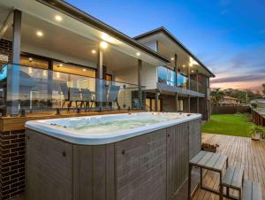 a large hot tub in the backyard of a house at Marea at Tanilba Bay in Lemon Tree Passage