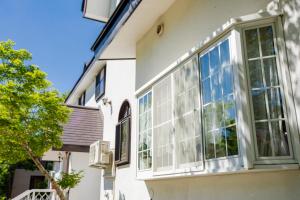 a house with large windows on the side of it at Pension Serenade in Hakuba