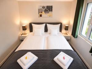 a bedroom with a large bed with two white pillows at Hotel Sternen Gurtnellen AG in Gurtnellen