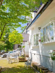 a house with statues in front of it at Pension Serenade in Hakuba