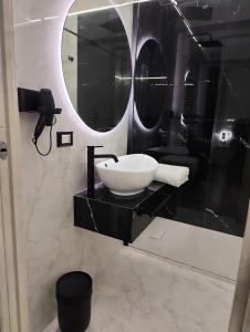 a bathroom with a sink and a mirror at Relax Rooms in Trapani