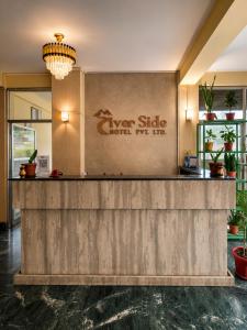 a lobby of a hotel with a reception counter at River Side Hotel Pvt Ltd in Tanahun