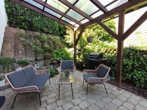 a patio with chairs and a table and a grill at NEU! Auszeit am Hirzenkopf in Steinberg-Deckenhardt