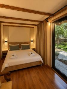a bedroom with a bed and a large window at Winery & Brewery - Family Guesthouse "Villa Rbona" in Khashuri +37 photos