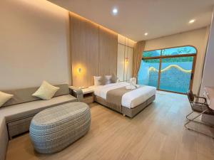 a hotel room with a bed and a couch at The Apex private pool villa Krabi in Krabi