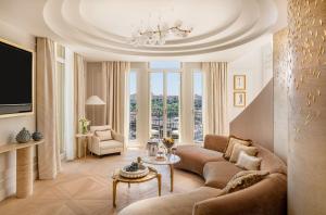 a living room with a couch and a table at Hôtel Hermitage Monte-Carlo in Monte Carlo