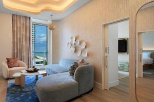 a living room with a couch and a chair at Andaz Miami Beach Resort & Spa in Miami Beach