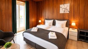 a bedroom with a large bed with towels on it at Hotel Sternen Gurtnellen AG in Gurtnellen +18 photos