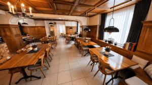 an overhead view of a restaurant with wooden tables and chairs at Hotel Sternen Gurtnellen AG in Gurtnellen