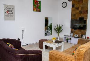a living room with two couches and a coffee table at Bamburi BnB in Mombasa