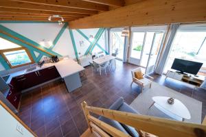 an overhead view of a living room with wooden ceilings at Chalet avec jardin et vue 6 personnes in Espezel