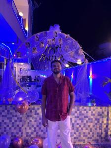 a man standing in front of a room with balloons at Lonavala Golden Bird 3 bhk villa in Malavli +73 photos