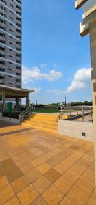a large patio with a building and a field at Cozy STUDIO for 4 Guests in Dasmariñas