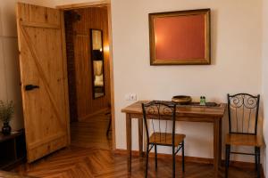 a room with a table and two chairs and a door at Winery & Brewery - Family Guesthouse "Villa Rbona" in Khashuri