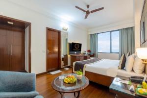 a hotel room with a bed and a couch at Foxoso The BMK - A Corporate Hotel in New Delhi