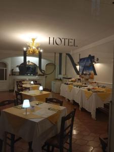 a group of tables in a room with a hotel at Hotel Luina in Stresa