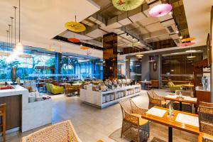 a restaurant with tables and chairs and a cafeteria at Soll Marina Hotel Serpong in Serpong