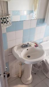 a bathroom with a white sink and a tub at Ruby's Place in Boscobel +33 photos