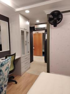 a room with a bed and a desk and a fan at Guest Room Star Avenue in Shah Alam